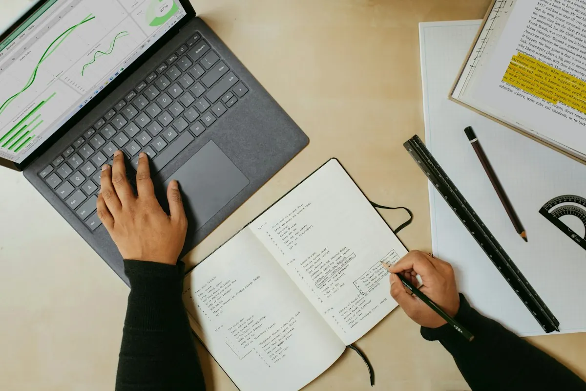 Writer planning content with analytics open on a laptop