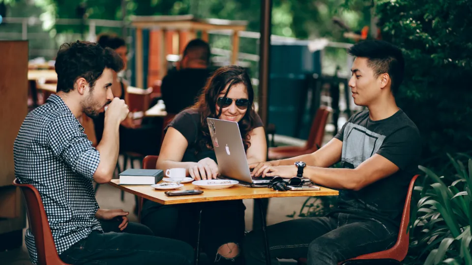 Friends talking around a table at an outdoor café