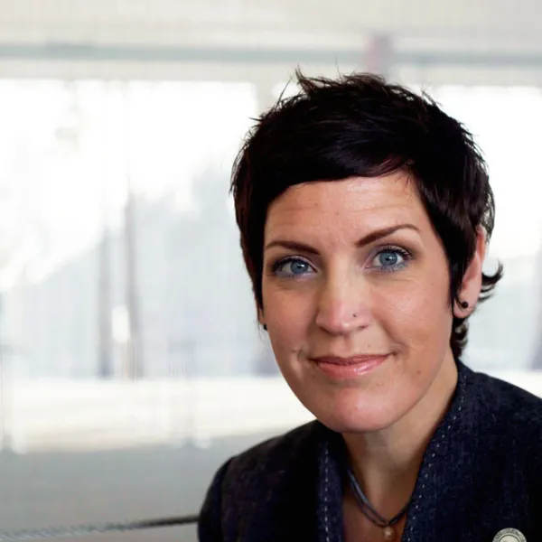 Portrait of host Maya Collins with short dark hair