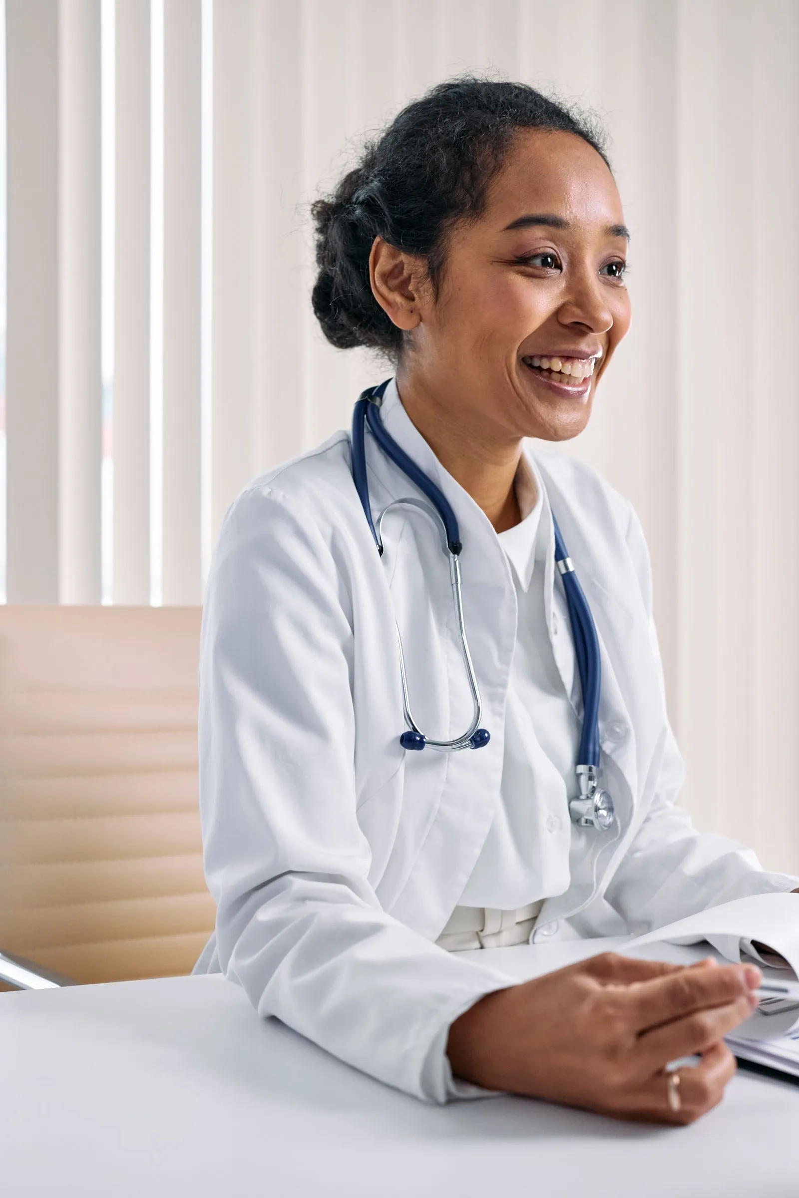 Portrait of Dr. Amara Okafor smiling in a white coat